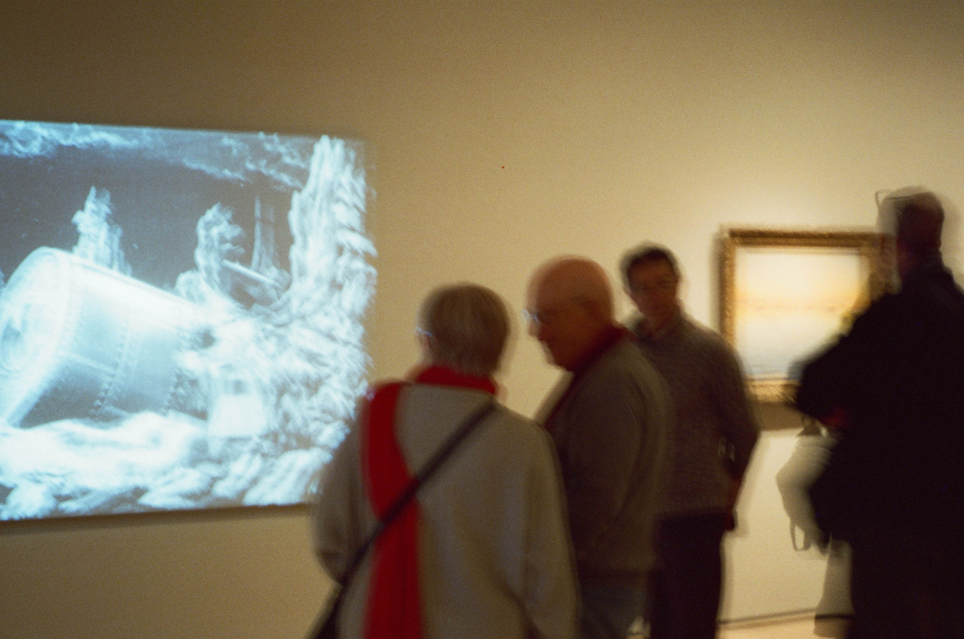 Visitors moving through a gallery